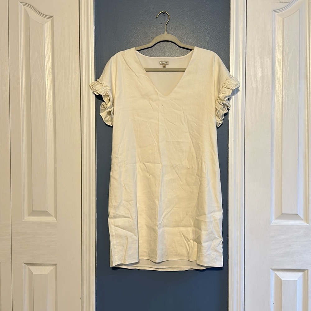 White dress with ruffles on the arms